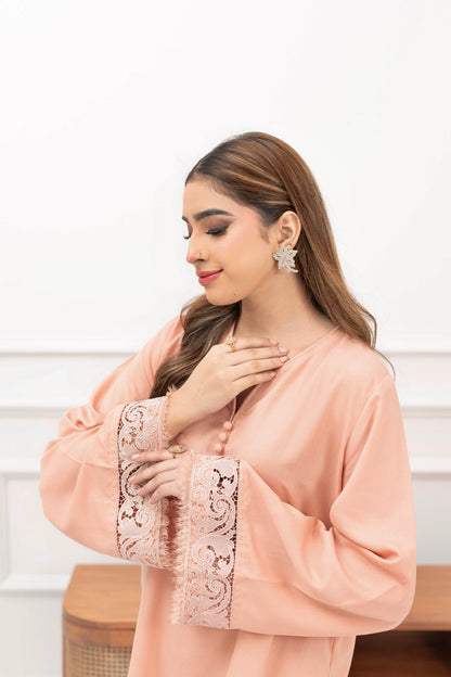 Angled view of powder pink karandi ready-to-wear women’s outfit styled against a white background.