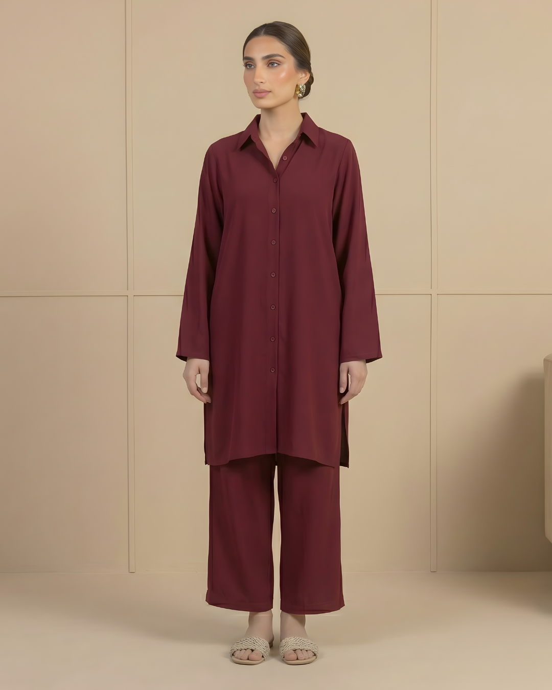 Woman wearing a deep red outfit against a beige background by Meryl Wear