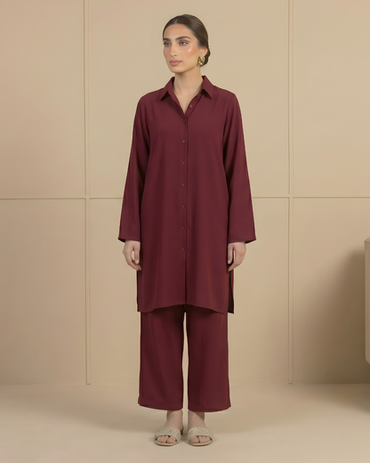 Woman wearing a deep red outfit against a beige background by Meryl Wear