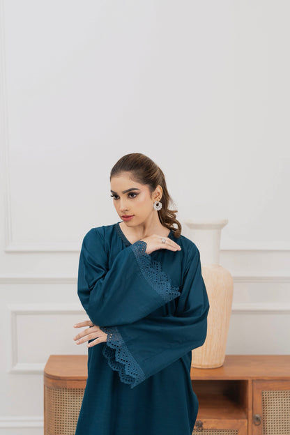 Front view of a deep teal women’s khaddar suit with embroidered shirt and coordinating trousers.