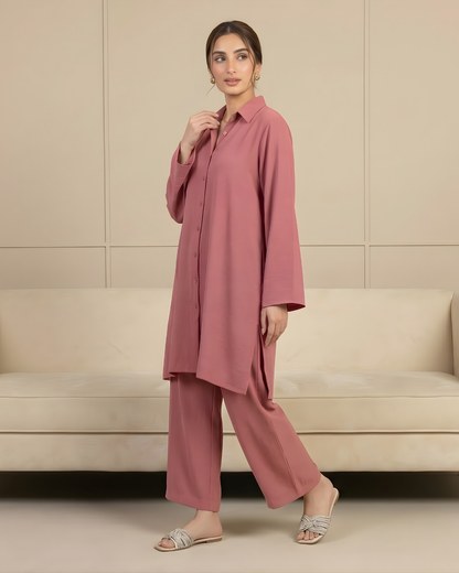 Woman wearing a pink two piece outfit by Meryl Wear